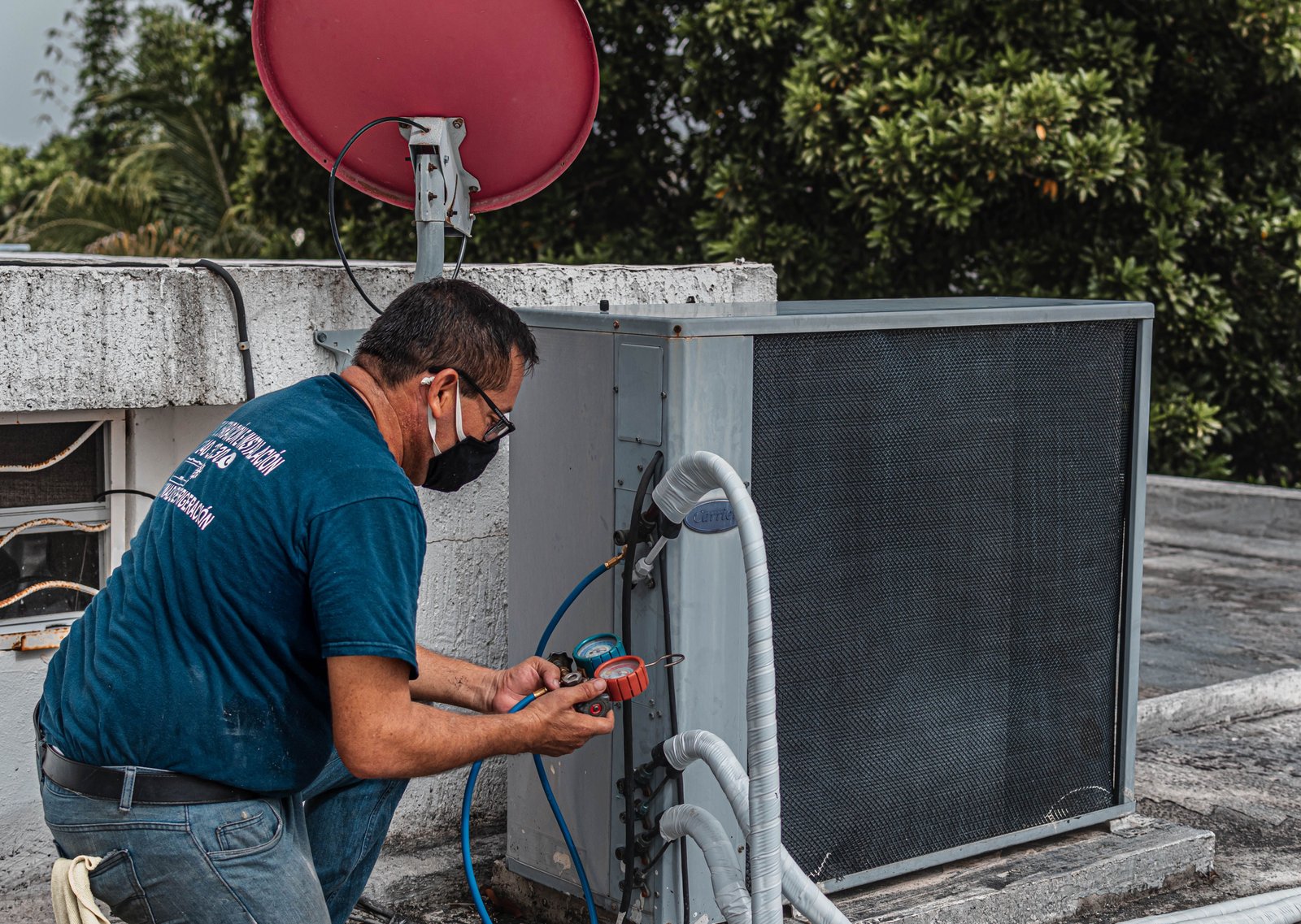 Technician servicing an outdoor air conditioning system